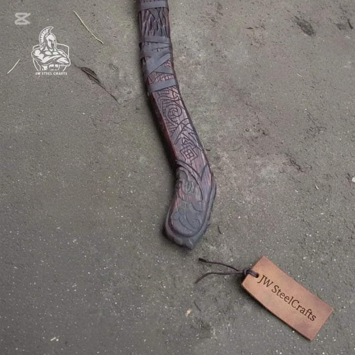 Northern Norse combat axe with decorative rune engravings and handcrafted wooden handle displayed on timber.