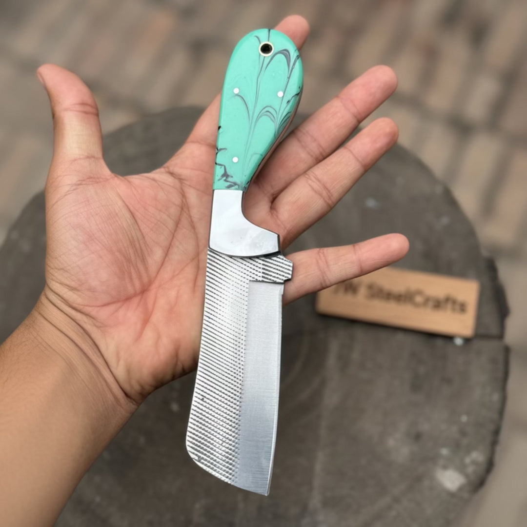     Compact mini cleaver style knife with turquoise handle and textured blade held in hand
