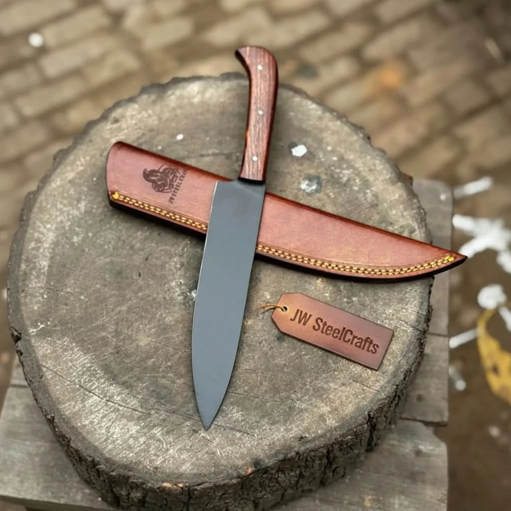 Rustic chef knife displayed vertically on a cut wood stump with leather blade cover