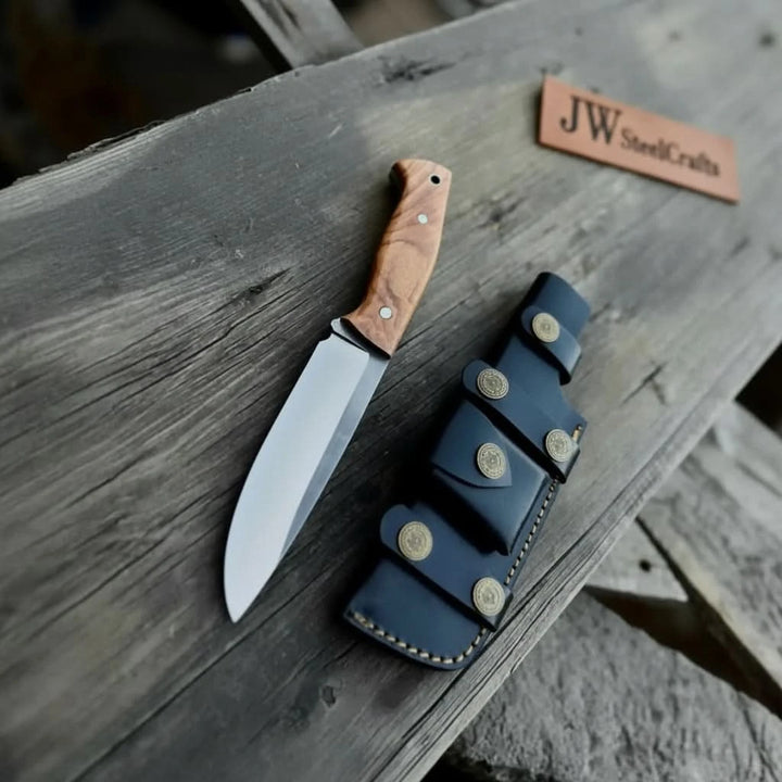 Weathered wood product photo showing a handmade knife, black leather sheath