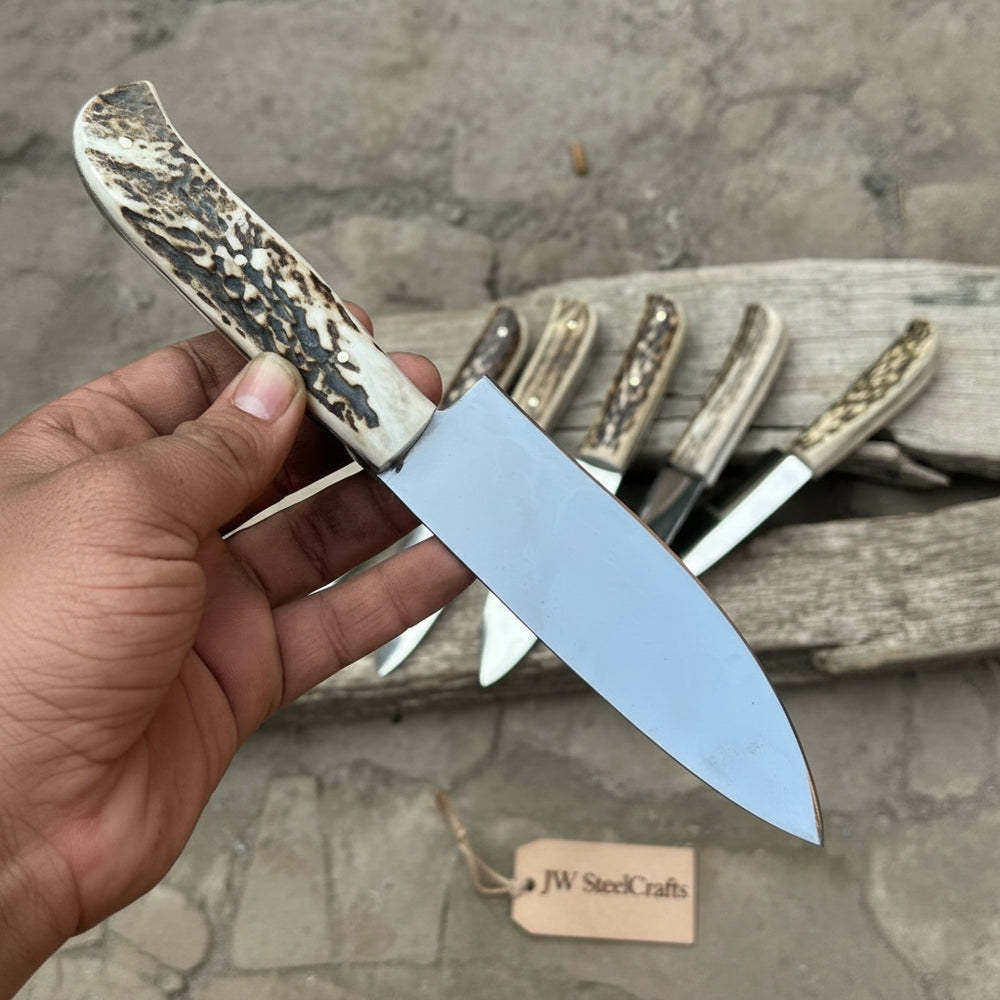 Chef butcher utility knife set with stag handles, polished steel blades, and six knives arranged on rustic wood.