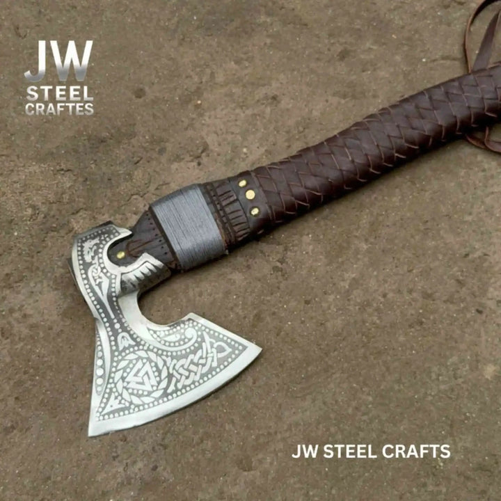 Forged Celtic battle hatchet showcasing ornate silver blade artwork and handcrafted leather textures.