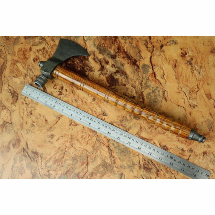     Engraved steel Viking axes display with artisan-forged curved blades and handcrafted hardwood handles on textured wood surface.