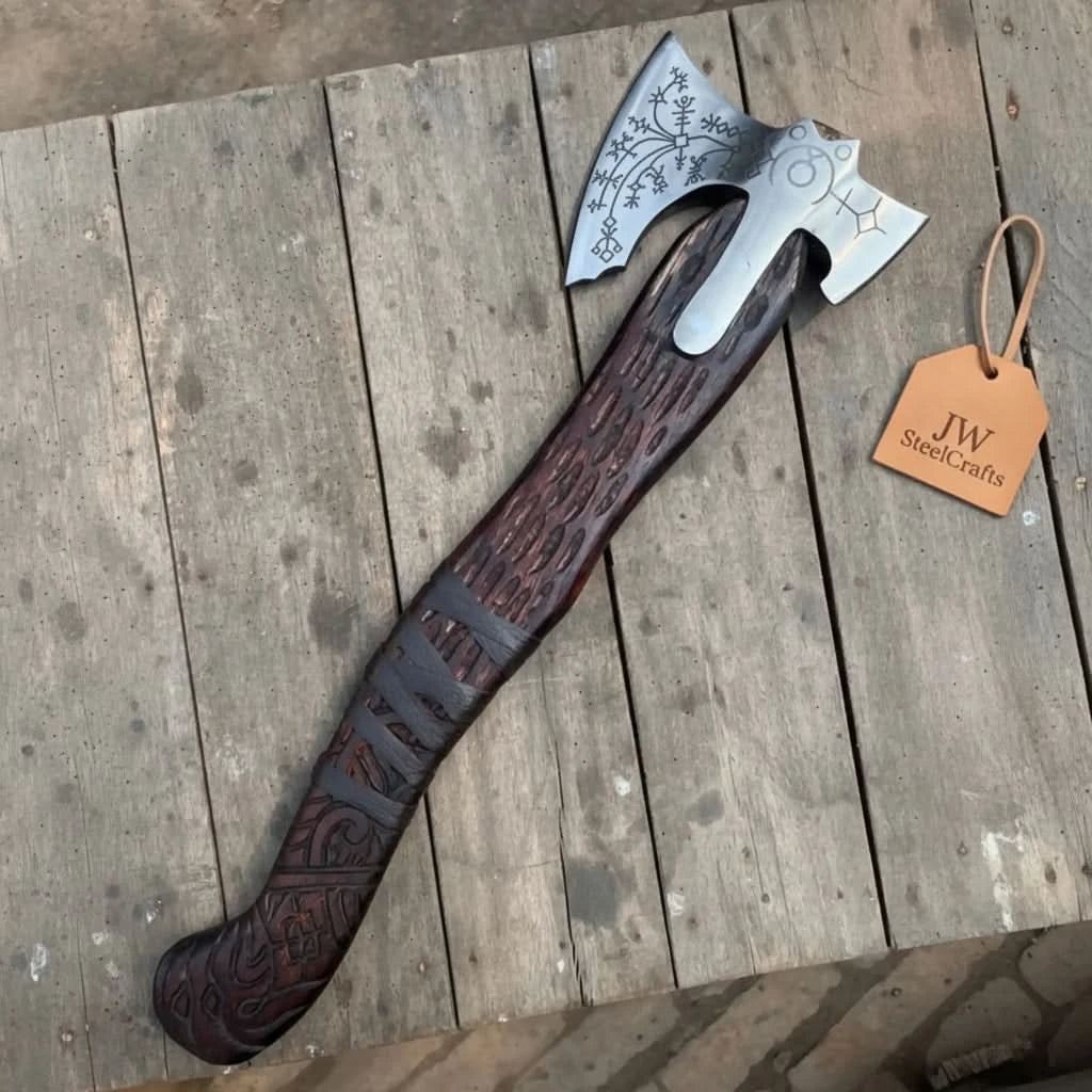 Phoenix-inspired Nordic rune axe featuring artistic steel etchings and carved hardwood grip.