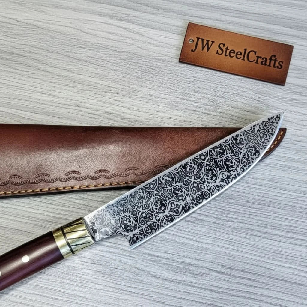 Engraved blade chef knife with brown leather sheath and decorative steel pattern