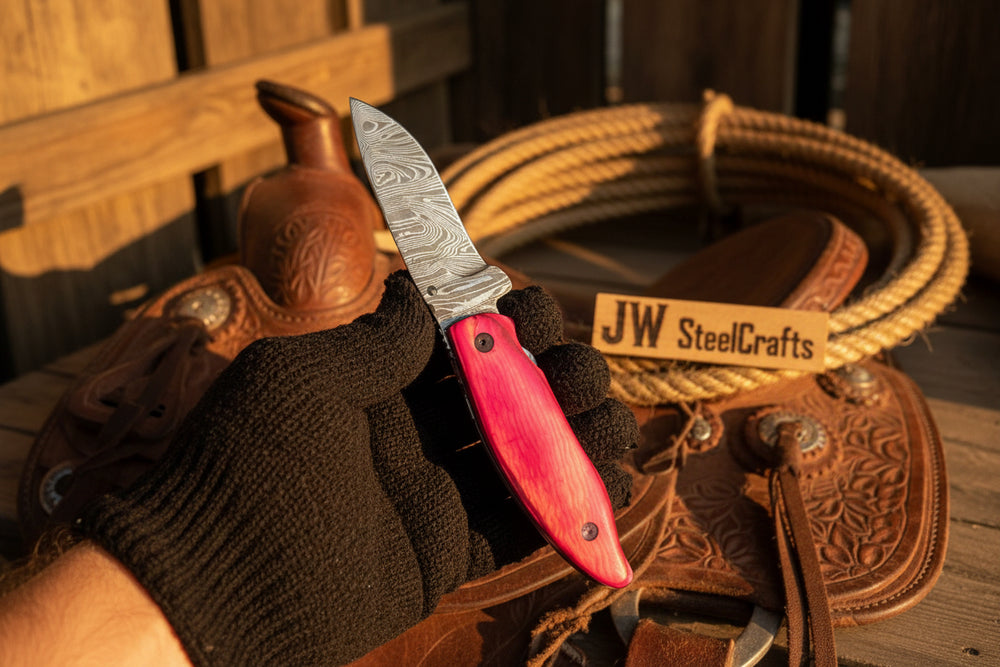 Pakka Wood Handmade Damascus Steel Folding Knife With Red Handle And Silver Blade On A Leather Bag