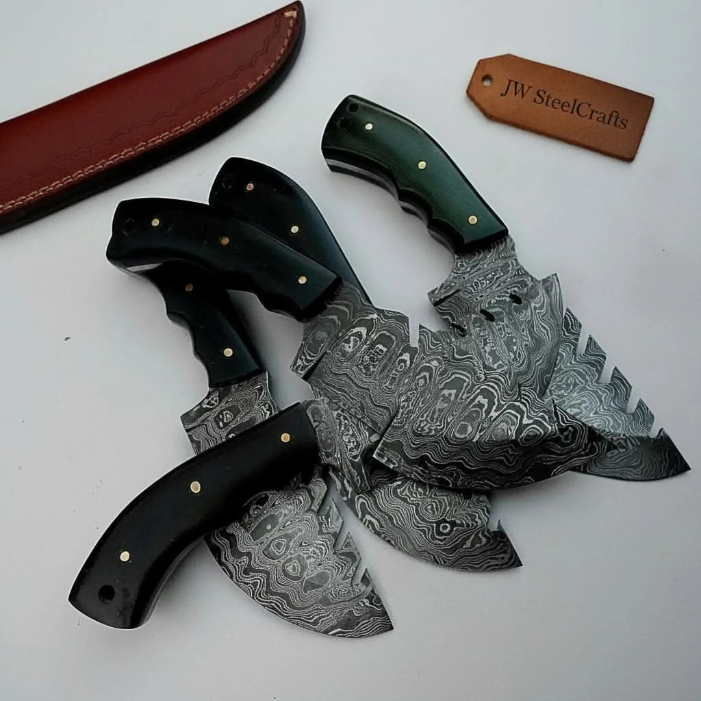 Handmade Damascus skinner blade set with sharp curved profiles and metal handle pins