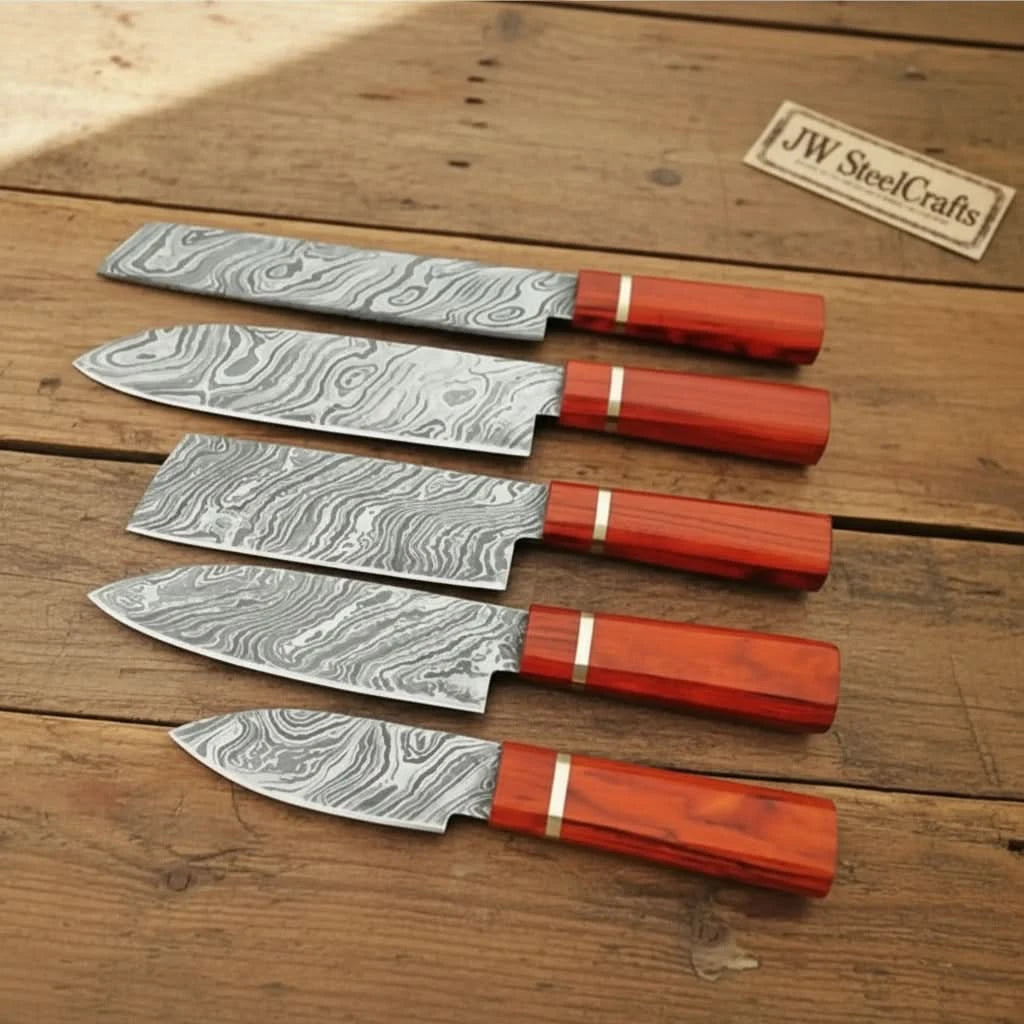 Red grip Damascus steel knives with sharp edges and decorative layered blade textures.
