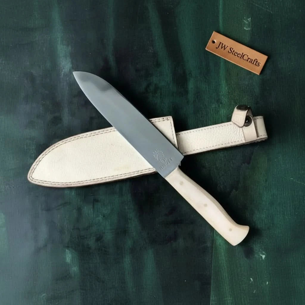 Minimal chef knife with cream sheath, smooth blade, and pale handle design