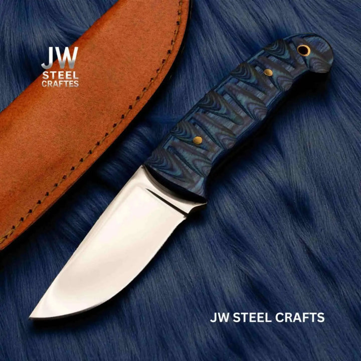Leather sheath fixed blade knife with blue handle, shiny steel blade, brass pins, and blue fabric background.