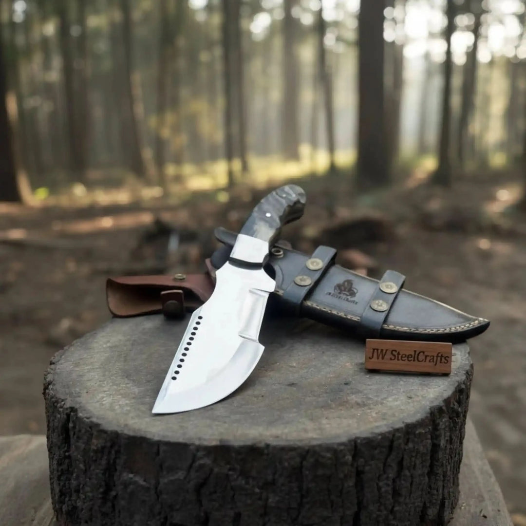 Outdoor fixed blade knife displayed with dual leather sheaths, one brown and one black, on a round tree stump.