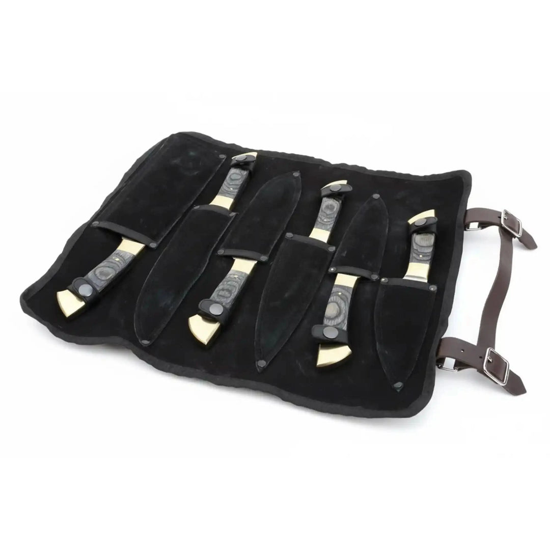 Black suede kitchen knife roll with buckle straps and dedicated slots for chef knife storage.
