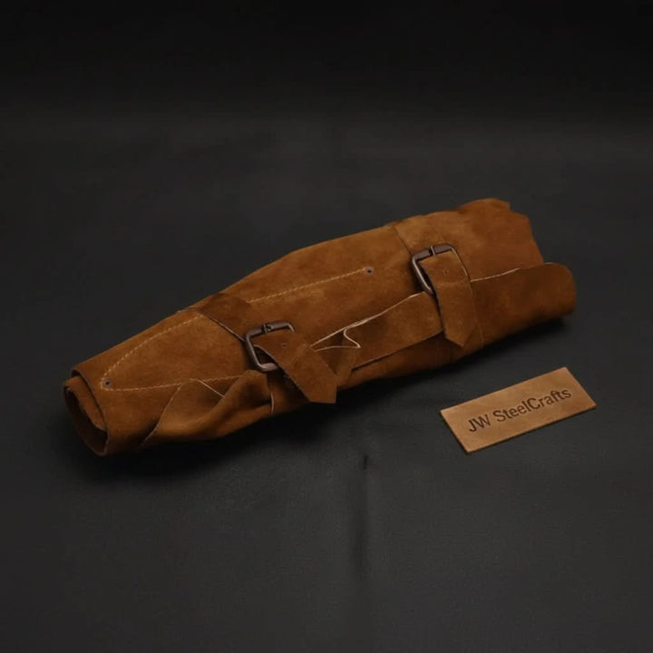 Compact chef knife organizer featuring handcrafted suede exterior and practical roll up storage functionality.
