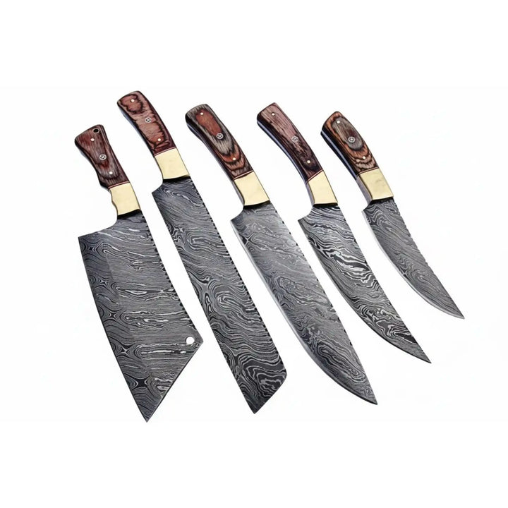 Artisan kitchen cutlery displayed on rugged timber workbench with industrial rivet detailing and outdoor countryside atmosphere.