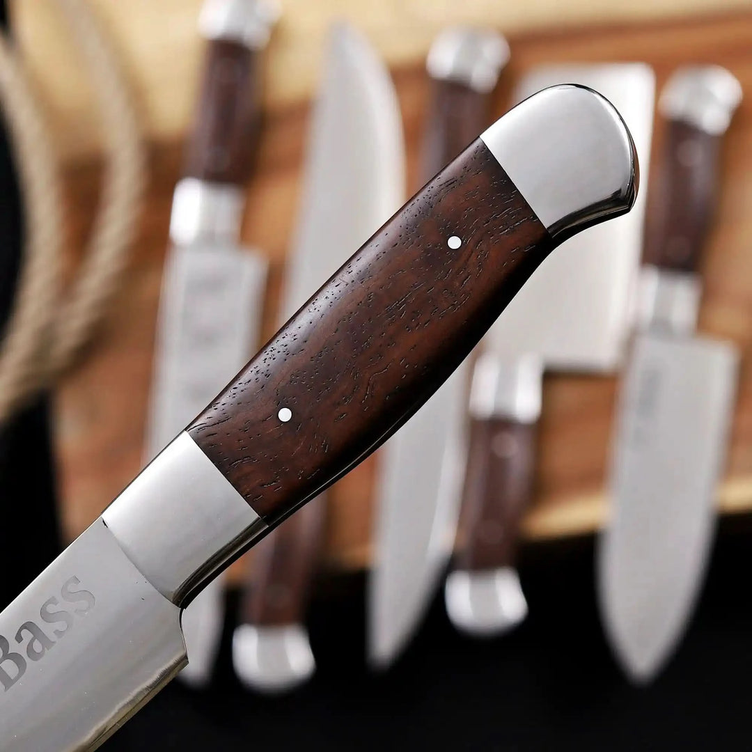 Ergonomic wooden handle of a professional full tang kitchen knife, showcasing the smooth grain and high-quality craftsmanship.