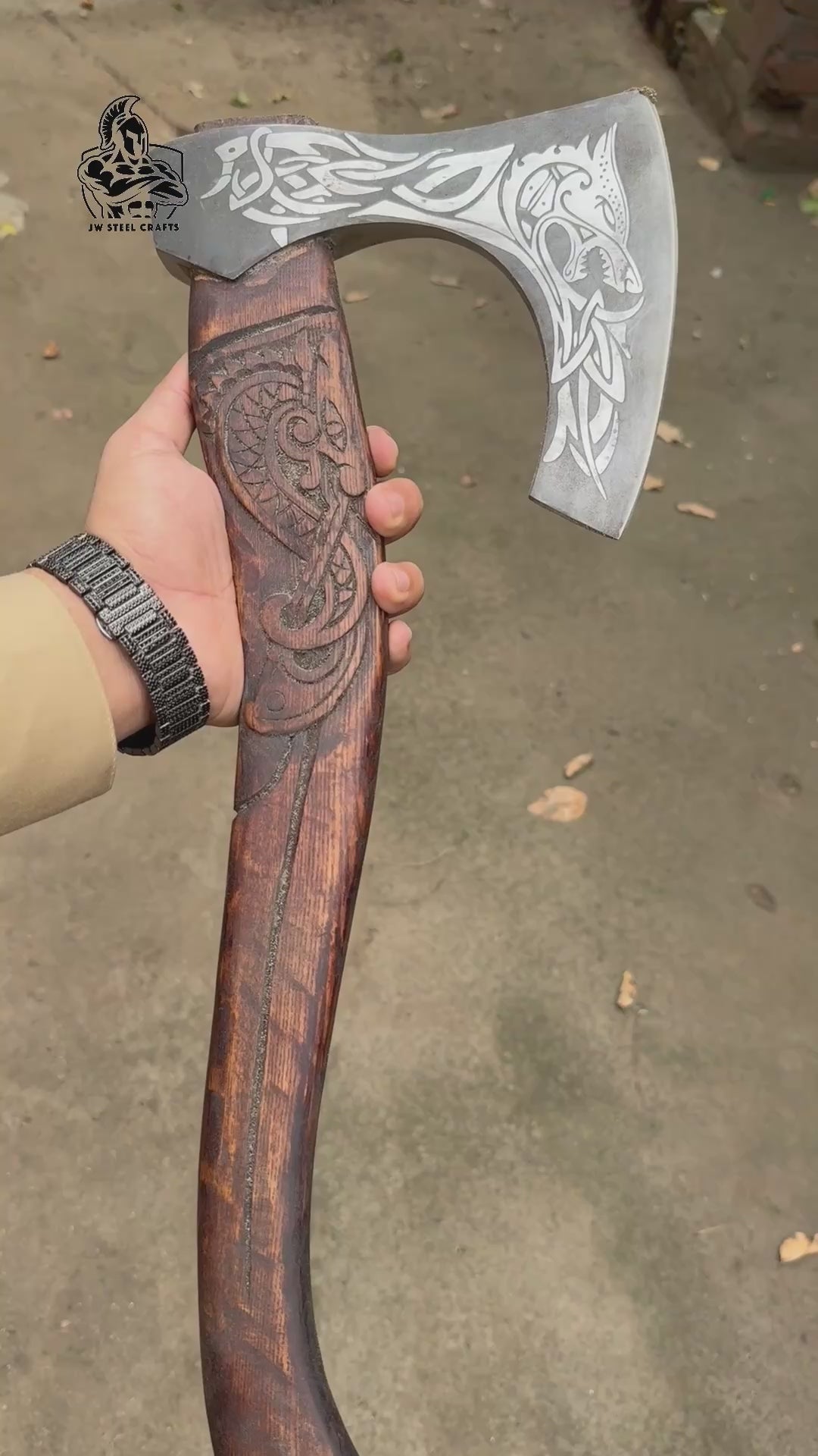 Frostthorn-themed Norse battle hatchet video displaying ornate raven blade patterns and artistic wood carvings.