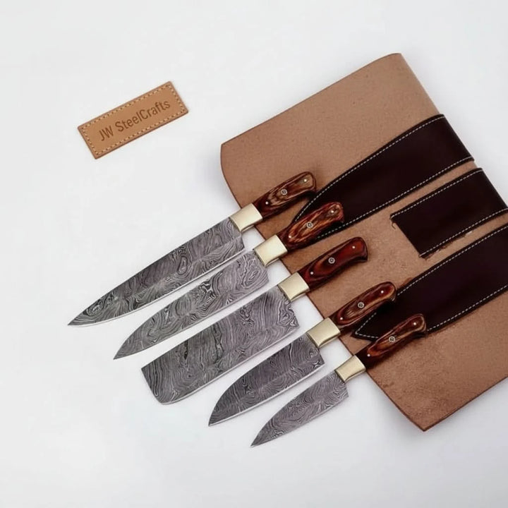 Artisan chef cutlery collection featuring slicing knife, cleaver blade, chef knife, santoku knife, and utility blade with layered steel textures.
