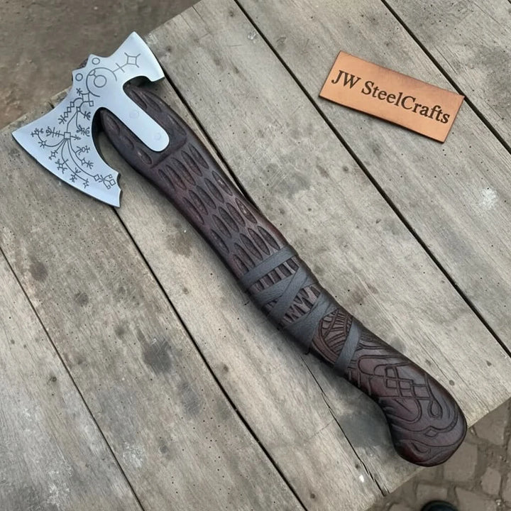 Raven-inspired Norse war axe display featuring engraved steel blade and textured carved wooden handle.