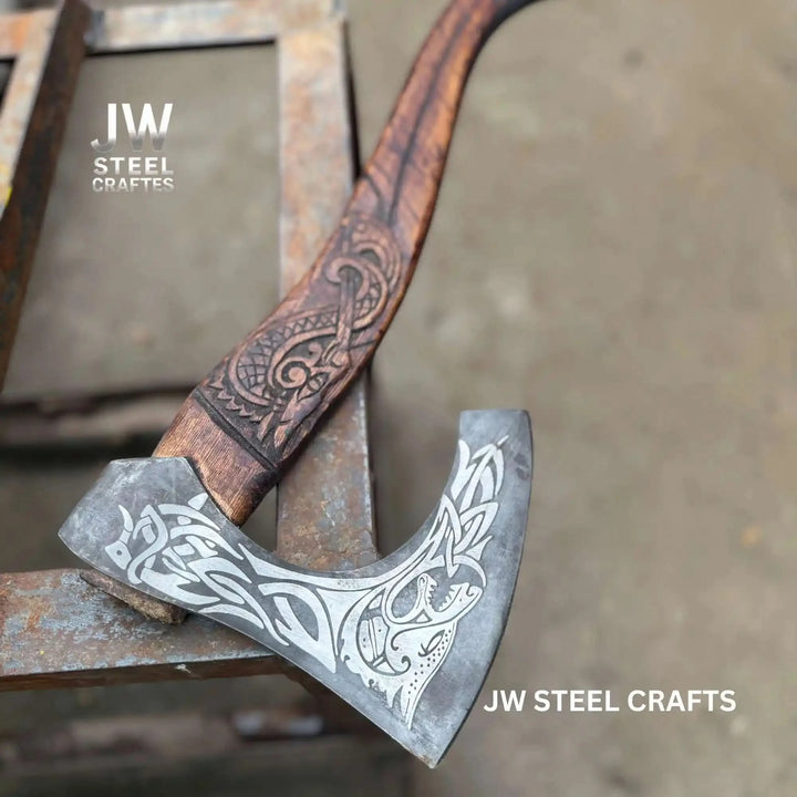 Northspire-themed Norse raven hatchet with intricate blade engravings and decorative carved wooden handle.