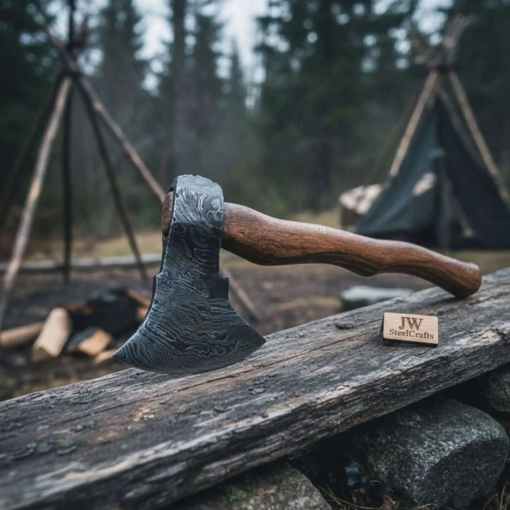 Stormvale-themed Viking battle hatchet displaying layered steel blade artwork and handcrafted curved handle.