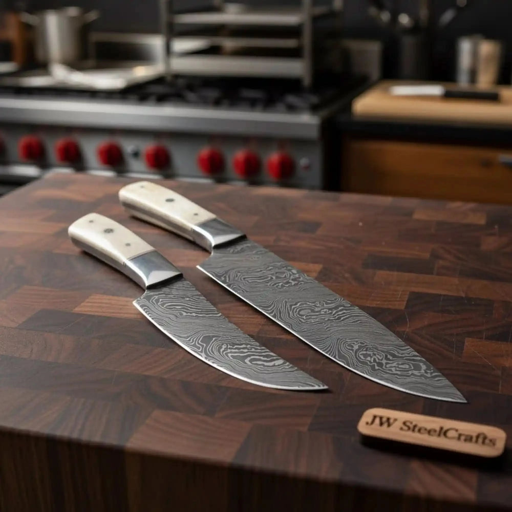 Stormgrain Damascus knife sheath display featuring black handles and detailed steel waves