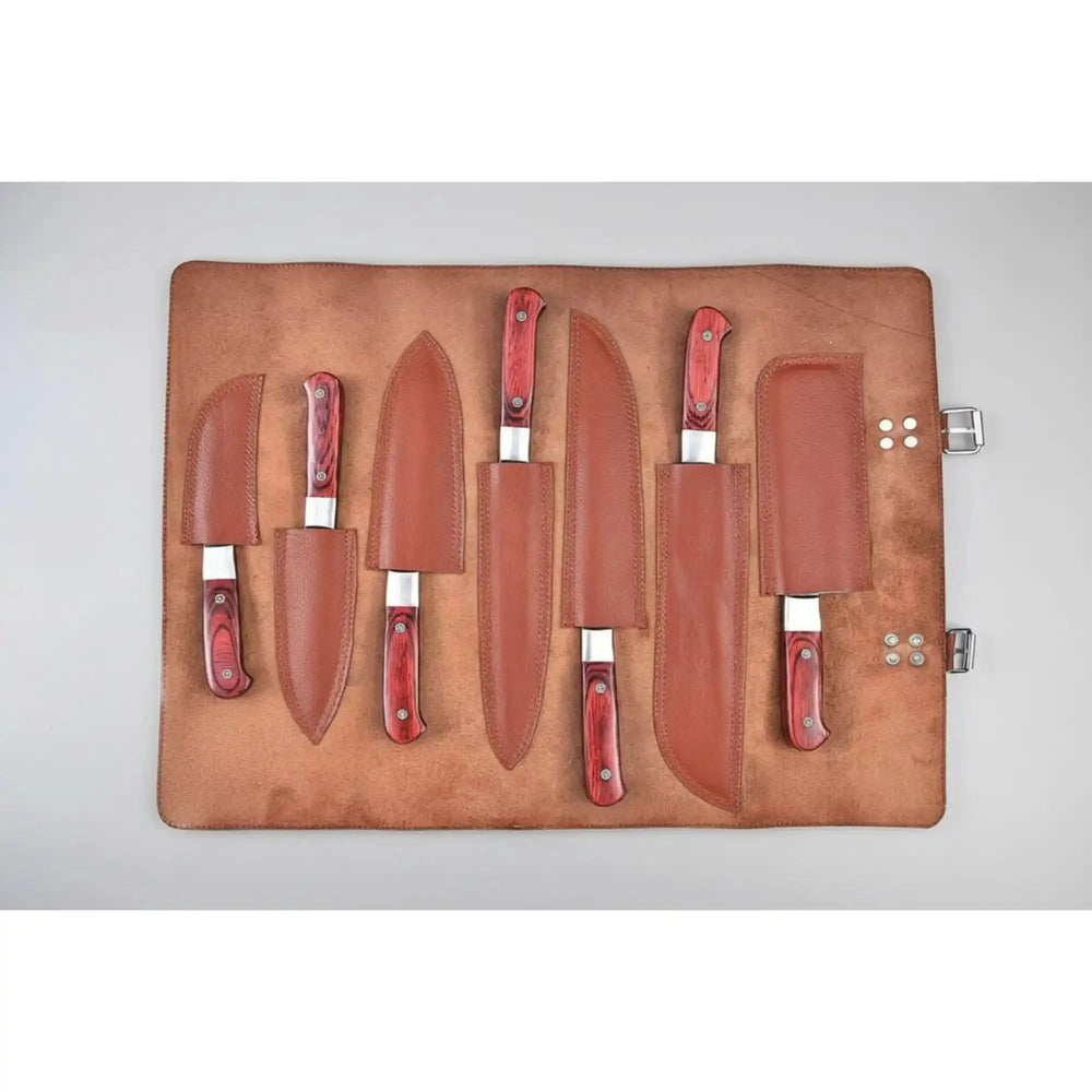 Top view of high-end Damascus kitchen cutlery featuring polished layered blades and elegant hardwood handles.