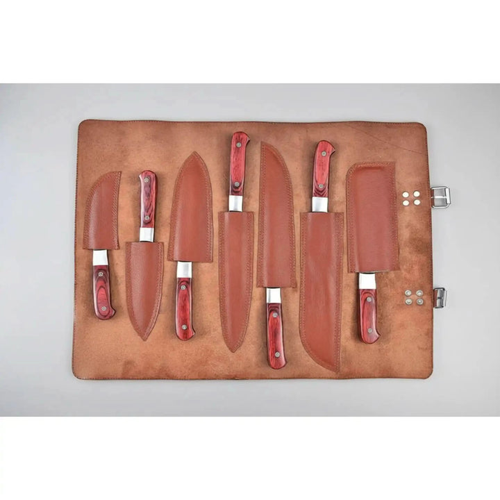 Top view of high-end Damascus kitchen cutlery featuring polished layered blades and elegant hardwood handles.