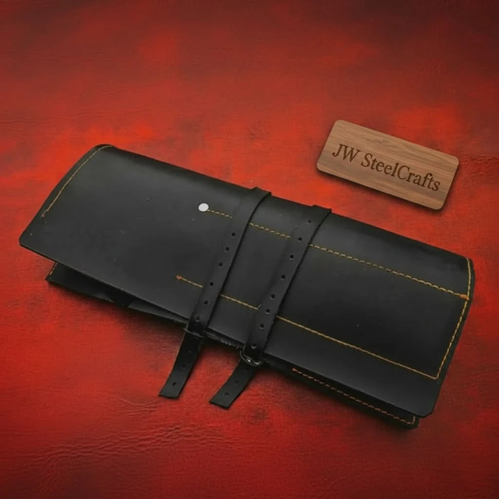 Folded kitchen cutlery storage roll featuring buckle straps and contrast stitching.