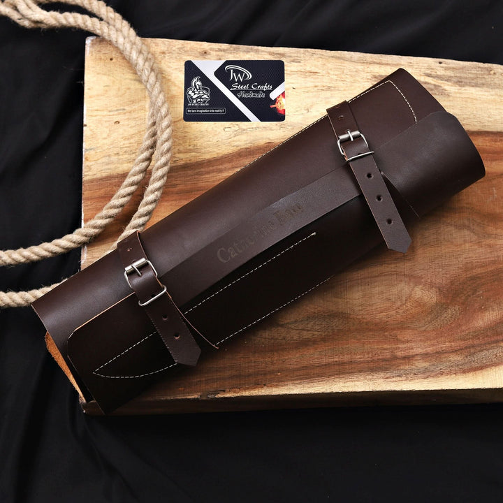 A premium dark brown leather knife roll bag with secure buckle straps, designed to hold a 6-piece handmade chef knife set safely.