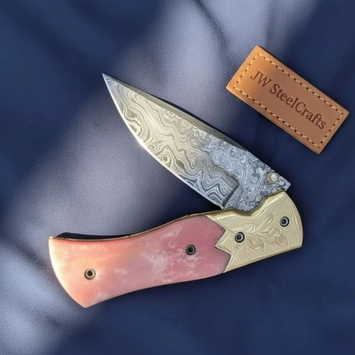     Blushforge pocket blade featuring artistic Damascus pattern and handcrafted folding knife craftsmanship for collectors