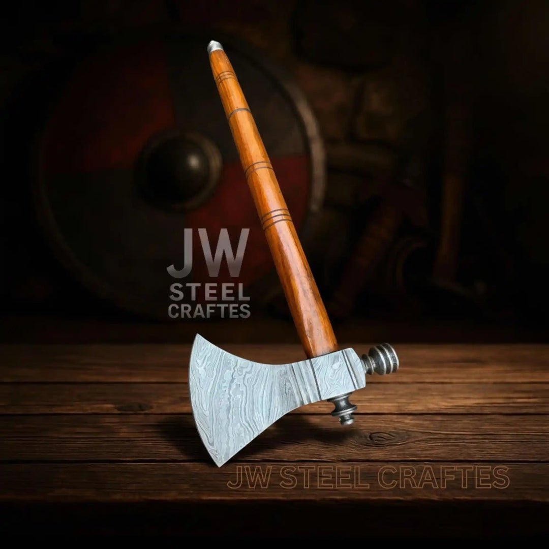 Striking Damascus warrior hatchet with sharp steel edge and polished brown wooden shaft.