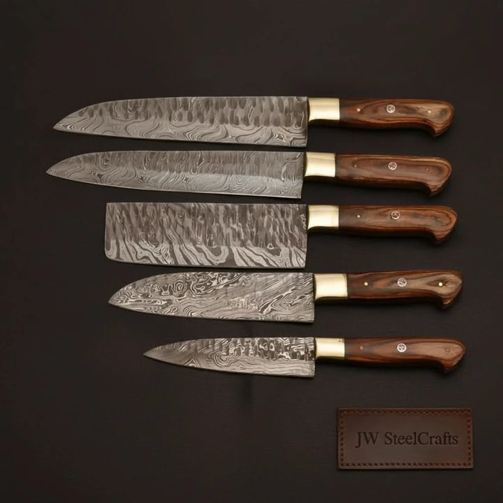 Decorative Damascus cooking knives with ergonomic wooden grips and precision sharpened cutting edges.