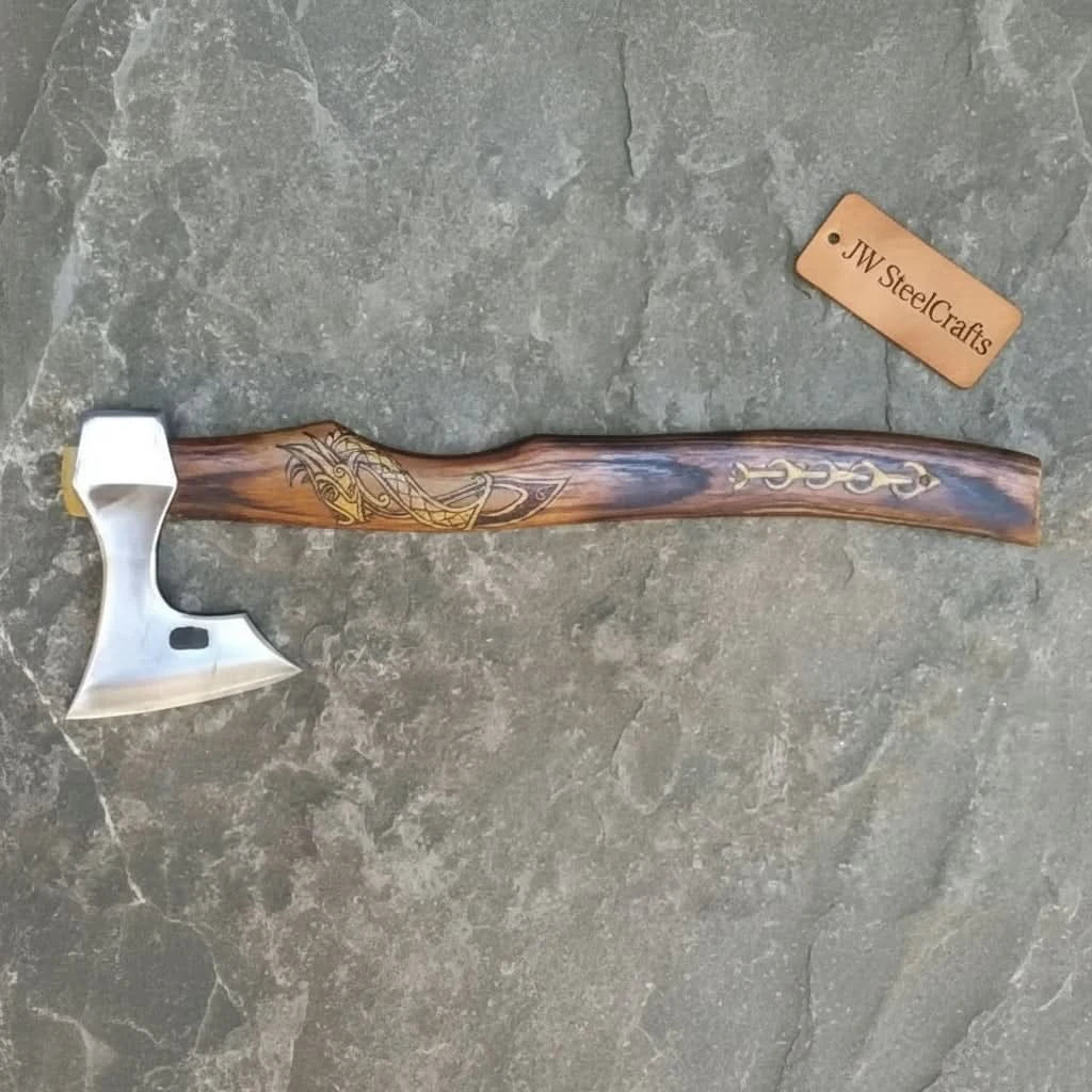     Traditional Norse-inspired axe with engraved Viking skull detail on the wooden handle and polished steel cutting edge.