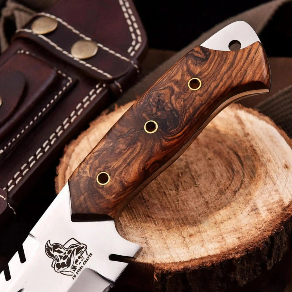 Heavy duty camping knife with sawback spine, angular polished blade, wooden handle, and dark leather sheath