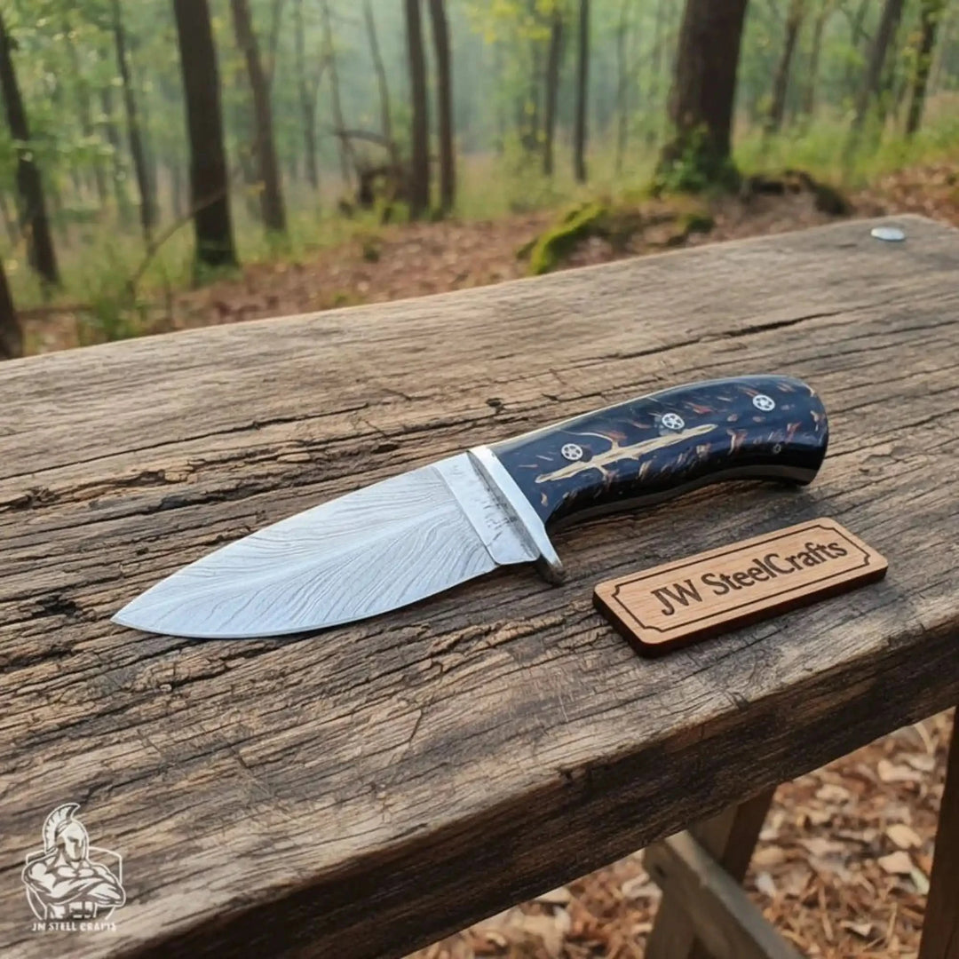 fixed blade knife with black resin grip, Damascus blade, silver bolster, mosaic pins, and JW SteelCrafts wooden label.