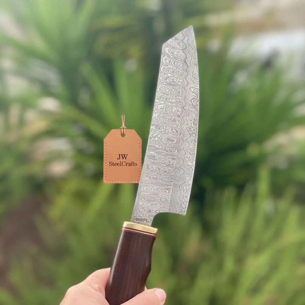 Traditional Japanese Damascus kitchen knife with slanted point and brass handle fitting