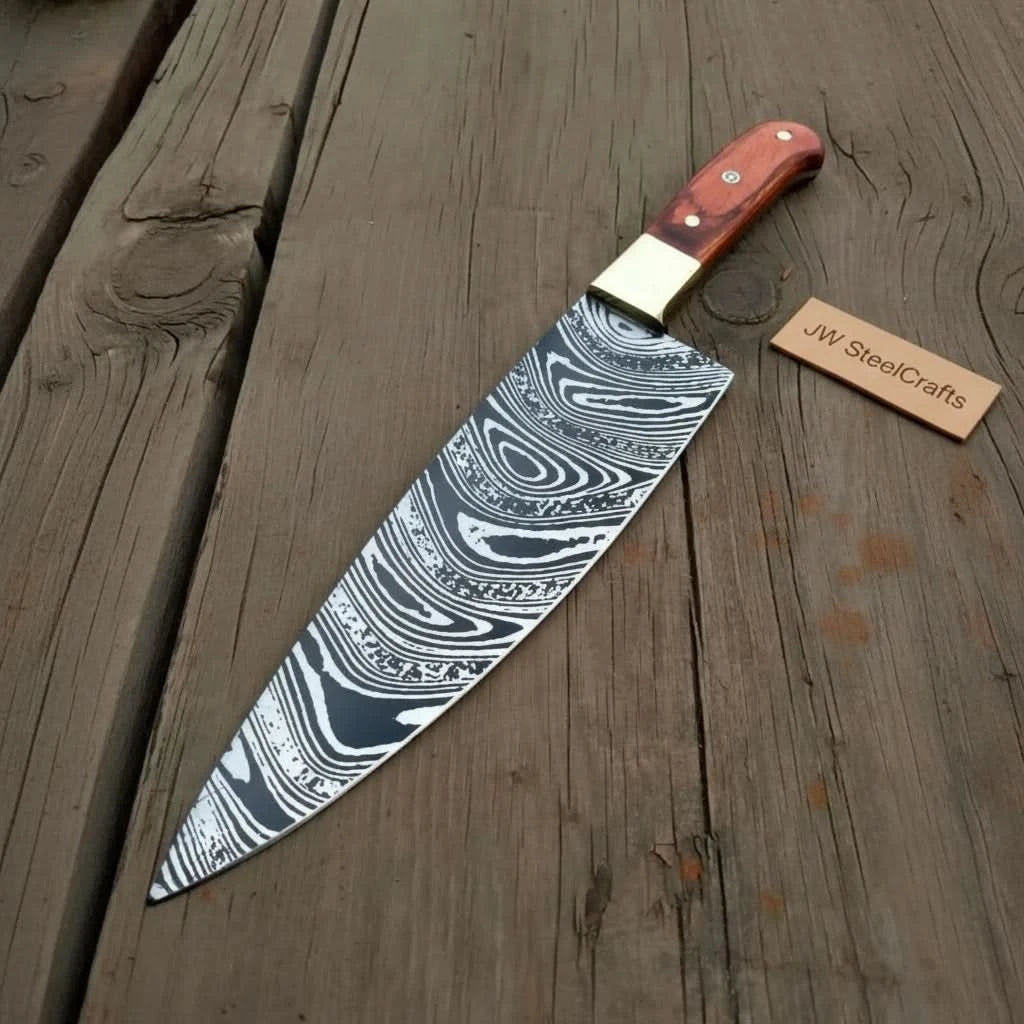High contrast Damascus knife on wood featuring long blade and warm red handle