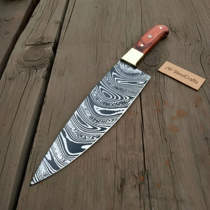 High contrast Damascus knife on wood featuring long blade and warm red handle
