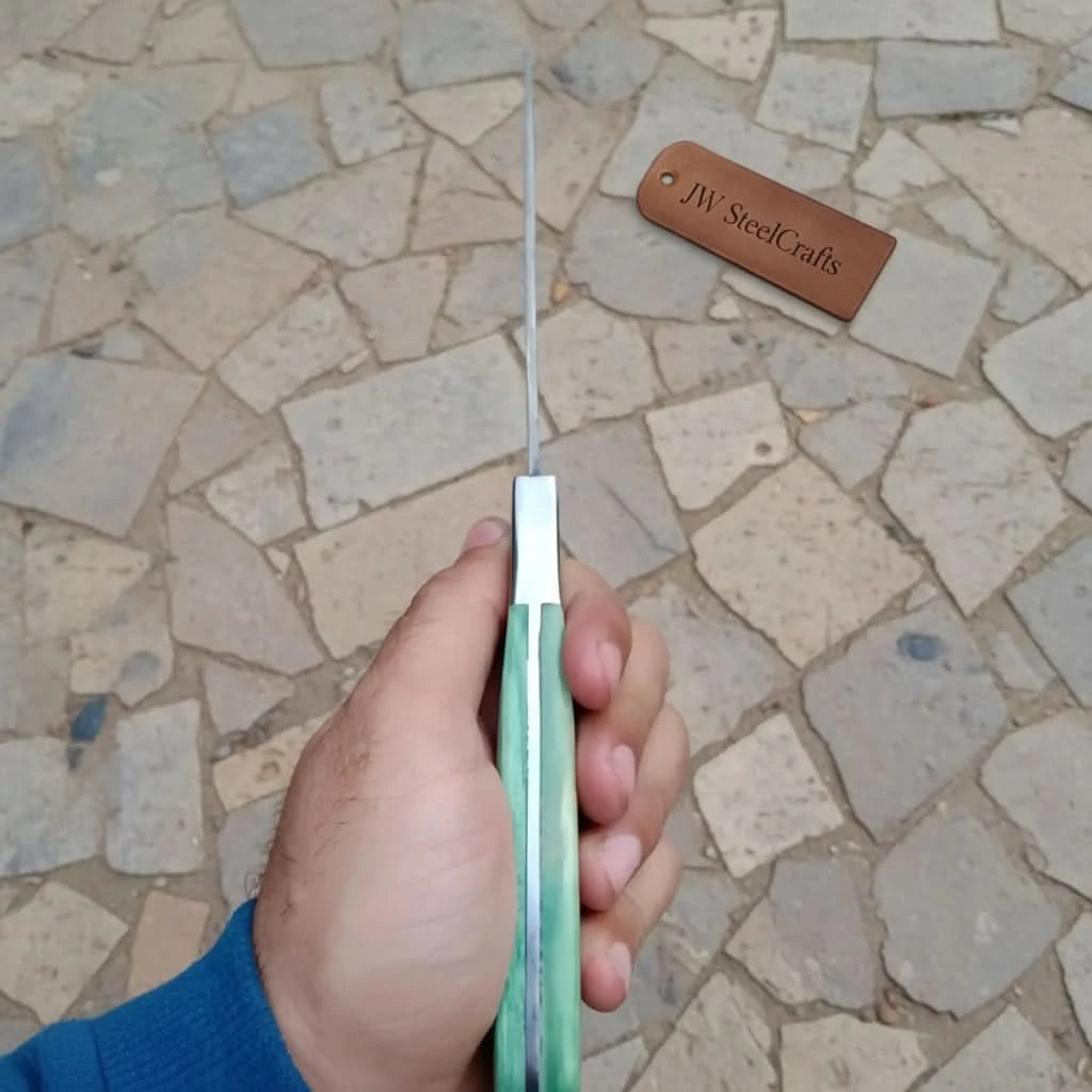 Edge view mint handle cleaver held in hand showing blade thickness and full tang construction