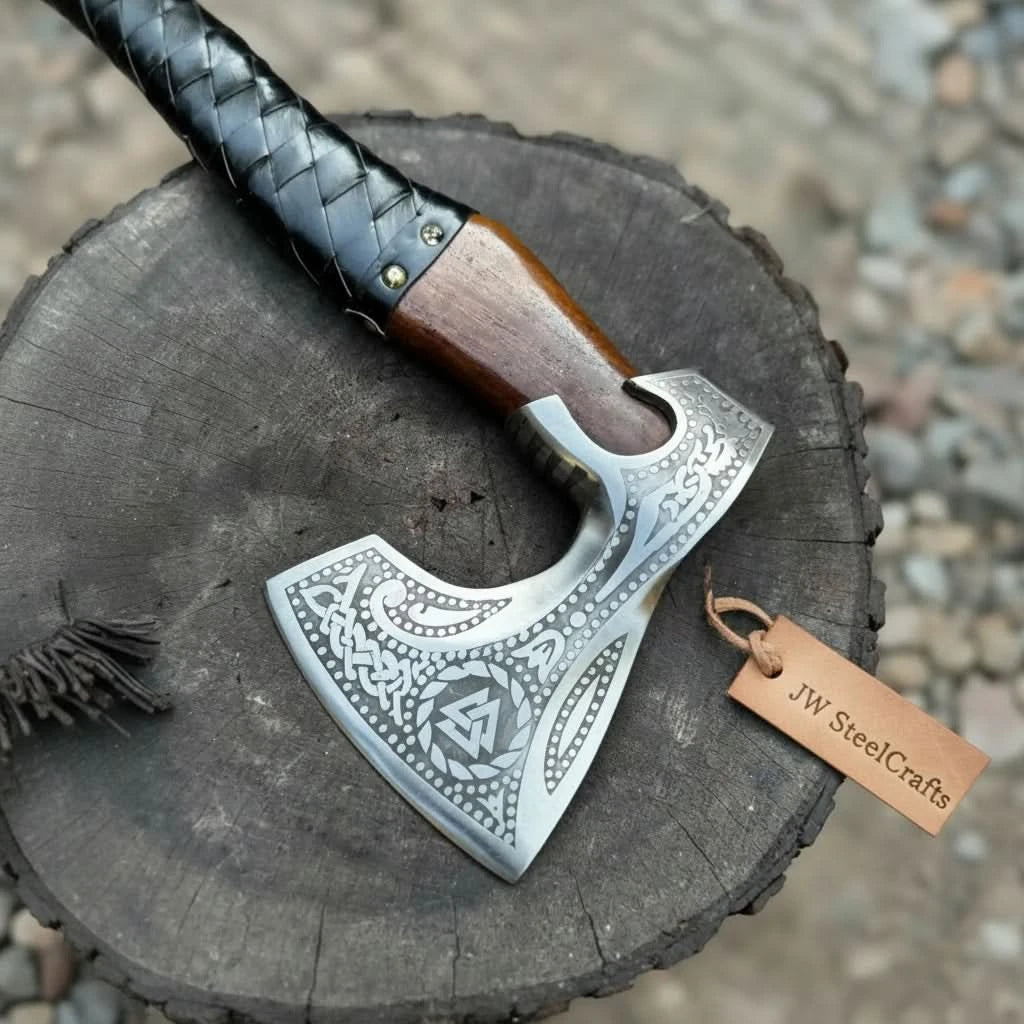 Thornveil-themed Nordic war hatchet showcasing handcrafted wood handle and stitched leather sheath outdoors.