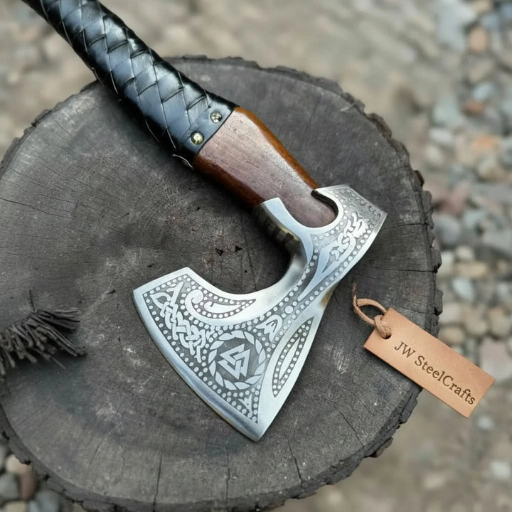 Thornveil-themed Nordic war hatchet showcasing handcrafted wood handle and stitched leather sheath outdoors.