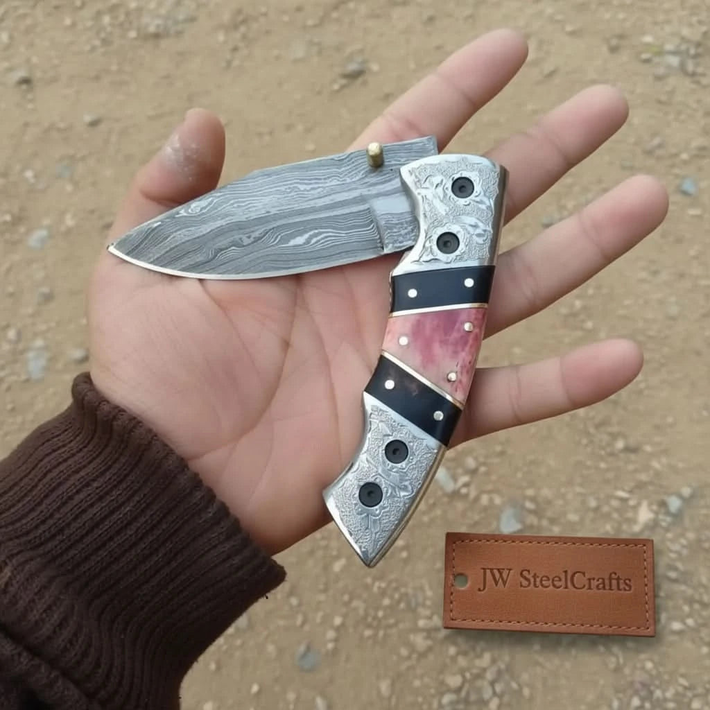     Ironvista folding blade with handcrafted Damascus pattern and stylish ergonomic pink black handle design