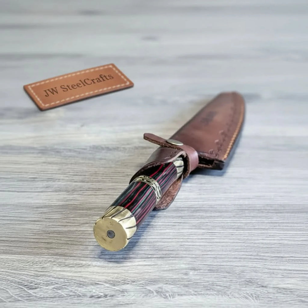 Brass pommel knife in sheath with decorative metal rings and stitched leather cover