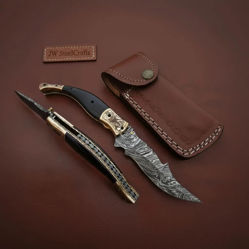     Unique artisan made Damascus folding pocket knife with engraved handle and curved steel blade details