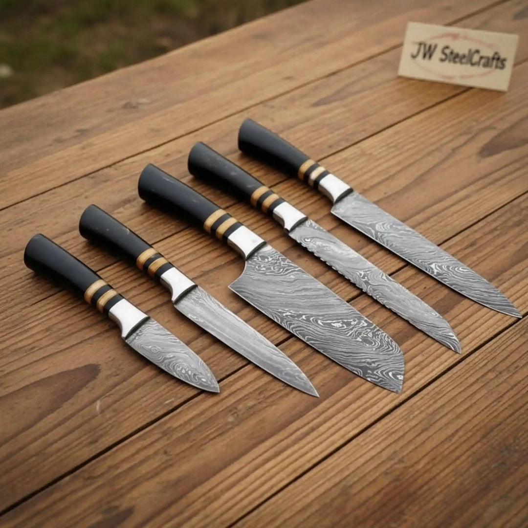 Signature Damascus chef blades with polished layered steel and refined black ergonomic grips.