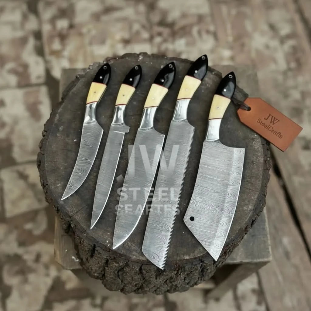 Top view of 5 piece Damascus chef knife set with camel bone and black micarta handles on tree stump