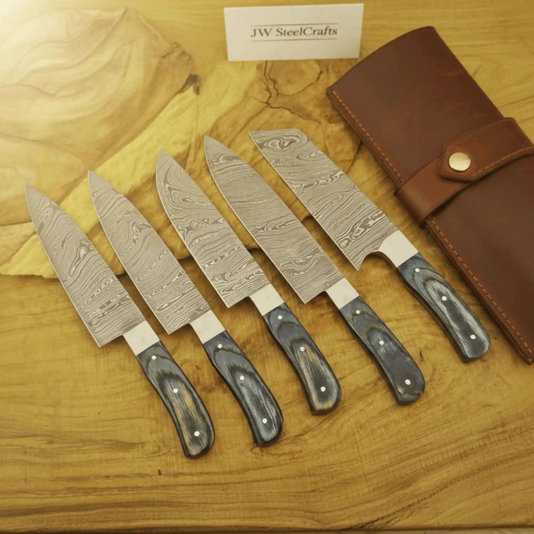 Cooking knife set with decorative steel grain and handcrafted ergonomic grips.