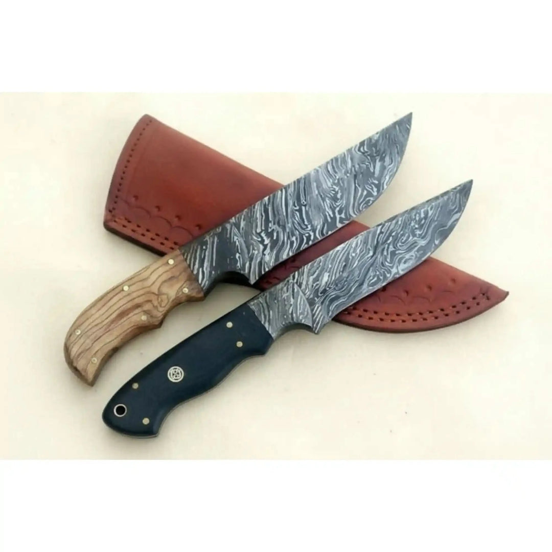 Large Damascus hunting knives with brown leather sheath, patterned steel blades, wooden handle, and black handle.