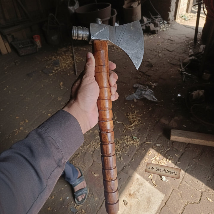 Warrior-style Damascus bushcraft axe with layered steel craftsmanship and warm wood handle textures.