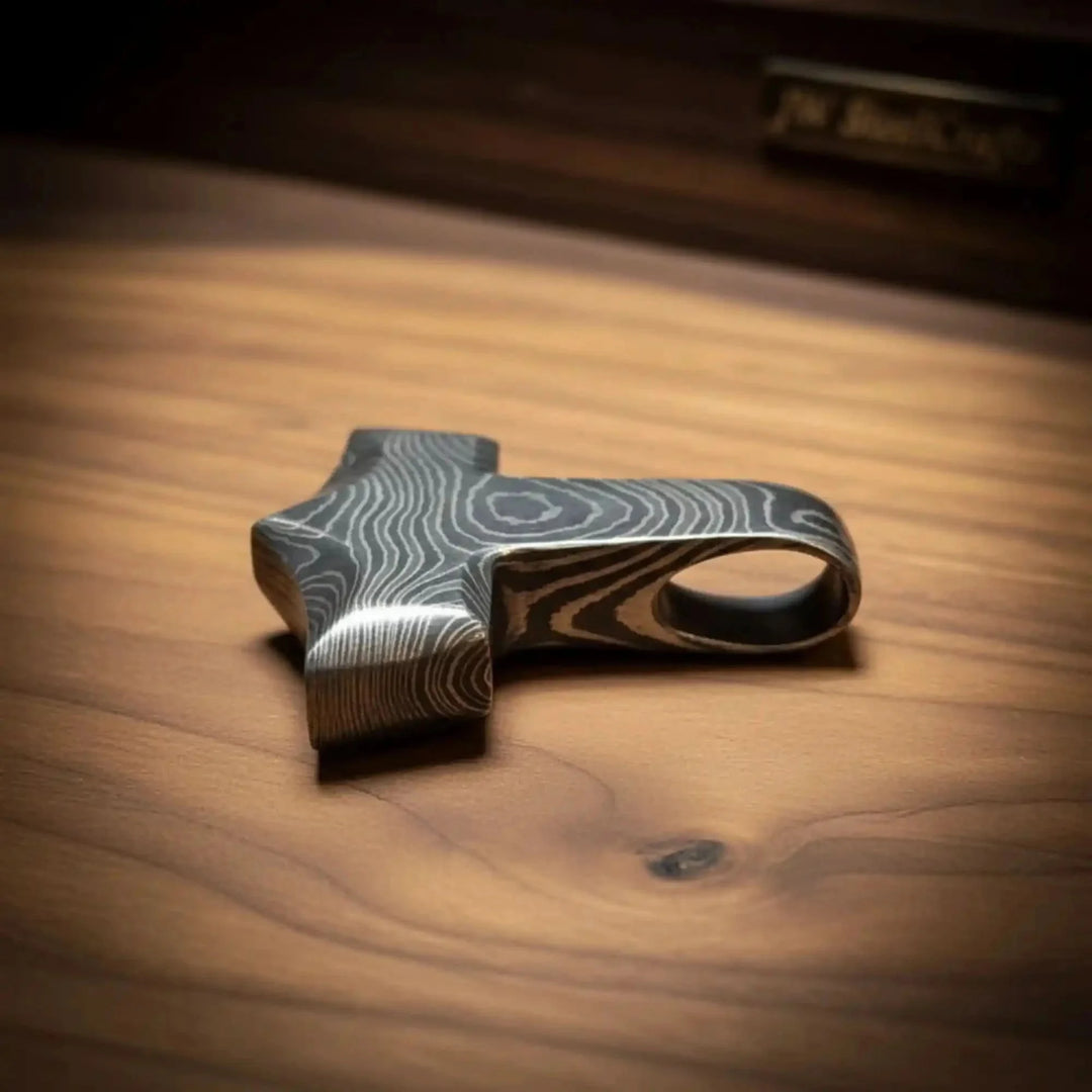 Viking Hrungnir Heart Pendant Damascus Steel Decorative Object With Wavy Pattern On A Wooden Surface
